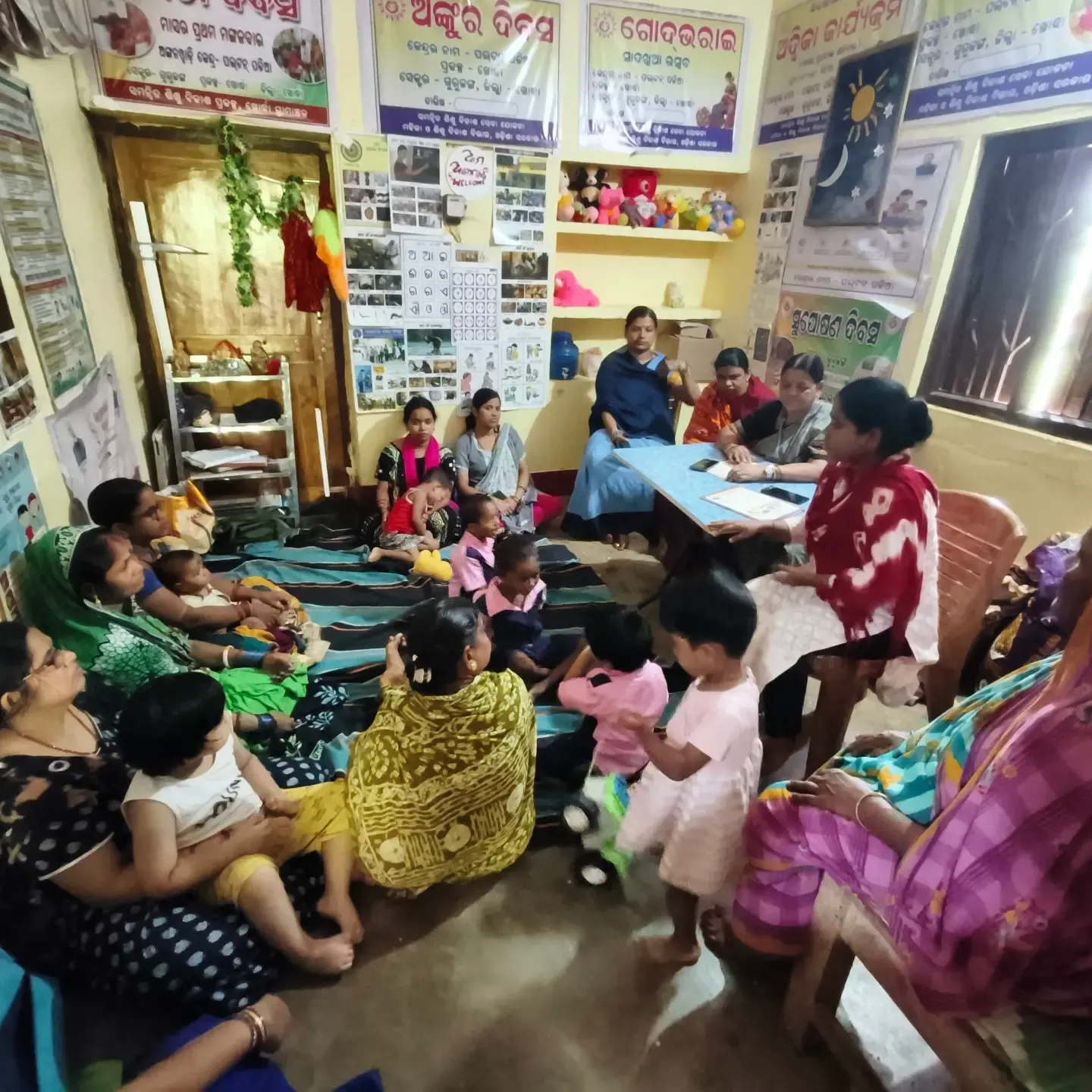 Mothers and children at an Anganwadi centre session