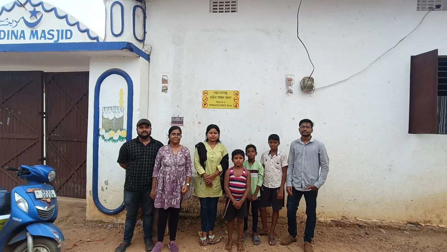 Volunteers at a tobacco-free zone sign